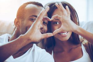 African American couple making a heart sign with their fingers
