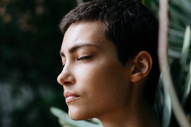 person standing in front of green plants